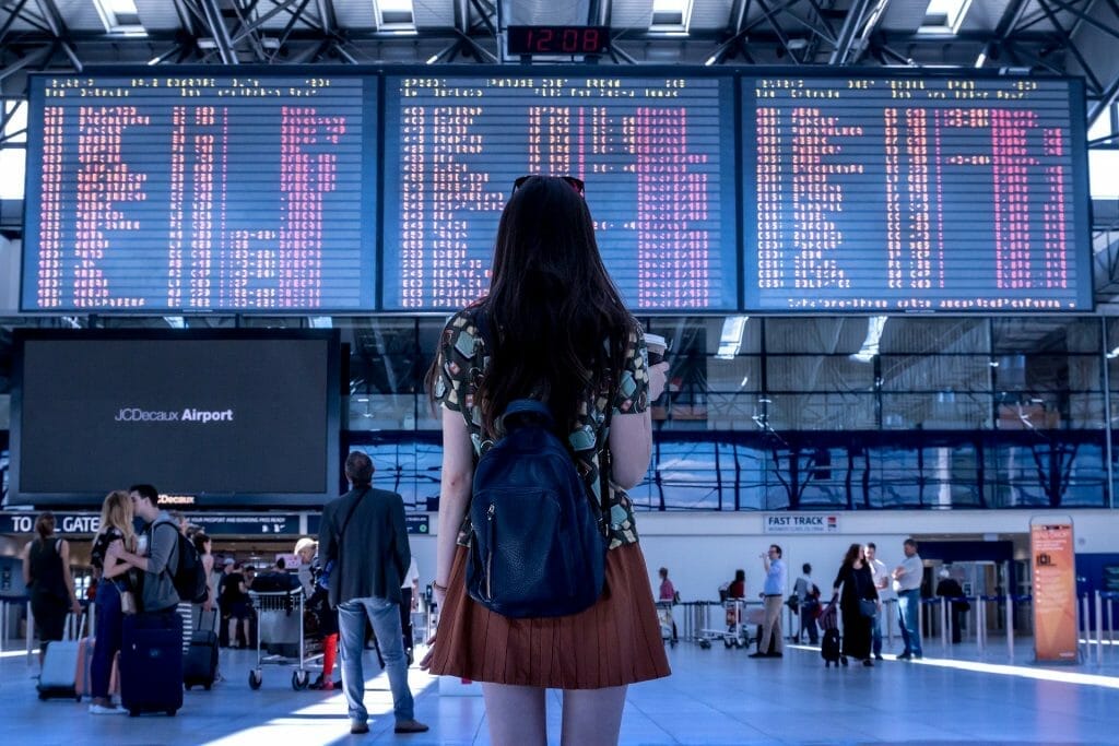 Nervous flyer woman staring at airport screen