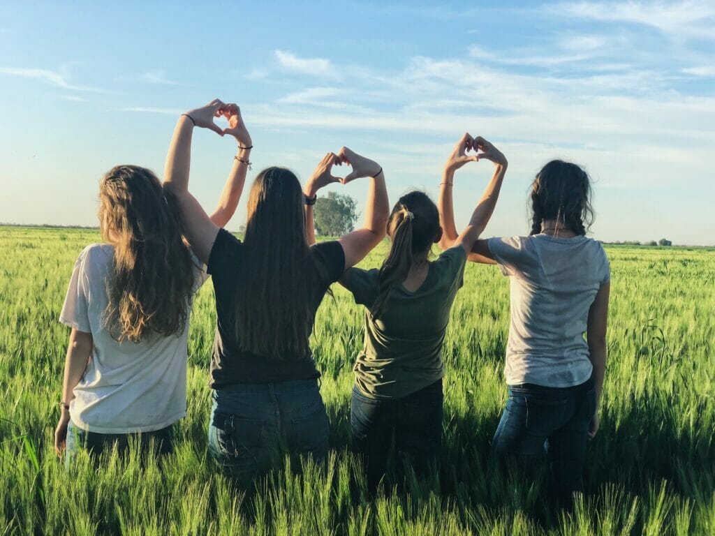 friends making hearts with hands