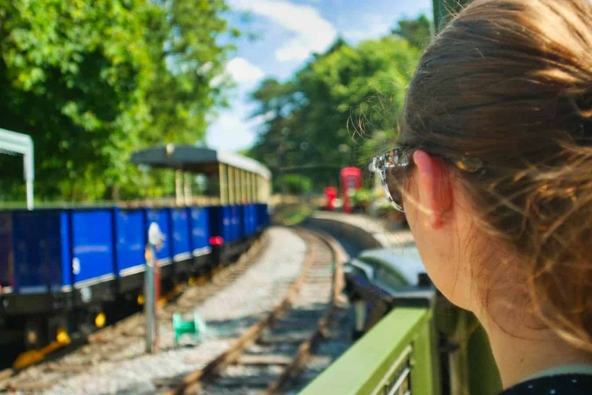 Kalyn looking at a blue train that can be ridden on through Whipsnade Zoo