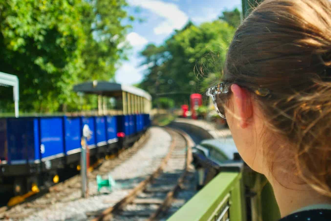 Kalyn looking at a blue train that can be ridden on through Whipsnade Zoo