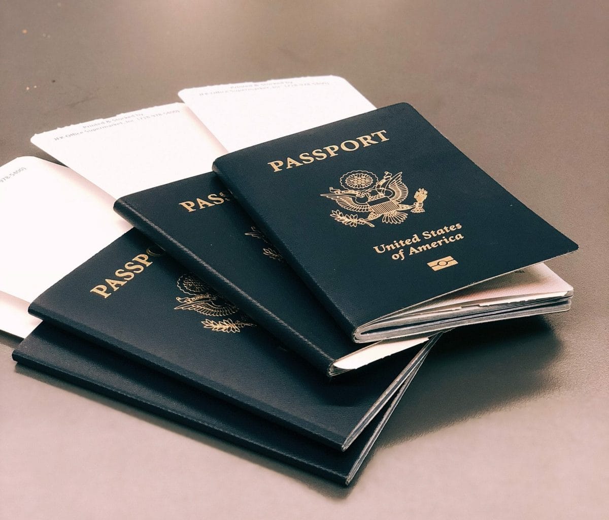 Four USA passports with boarding passes sticking out the top