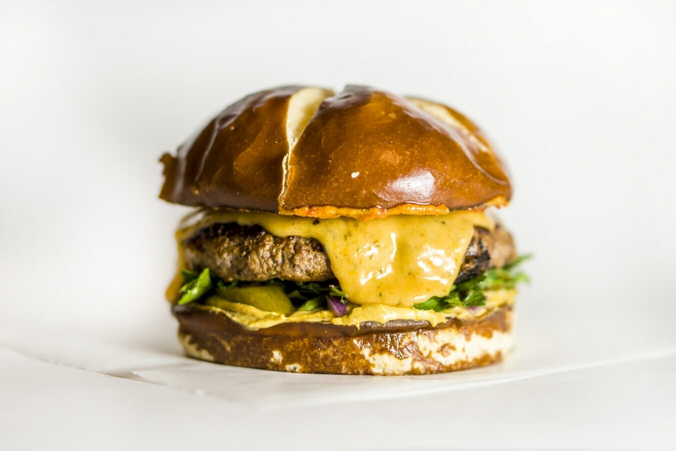 A burger with cheese melting down the side