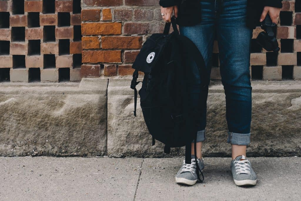 woman holding backpack