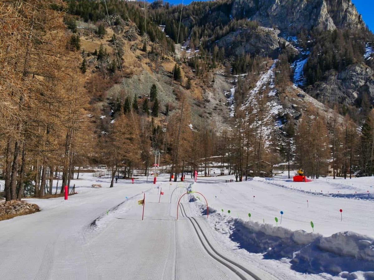 Beginners Nordic Ski area with slalom flags and arches with bells underneath