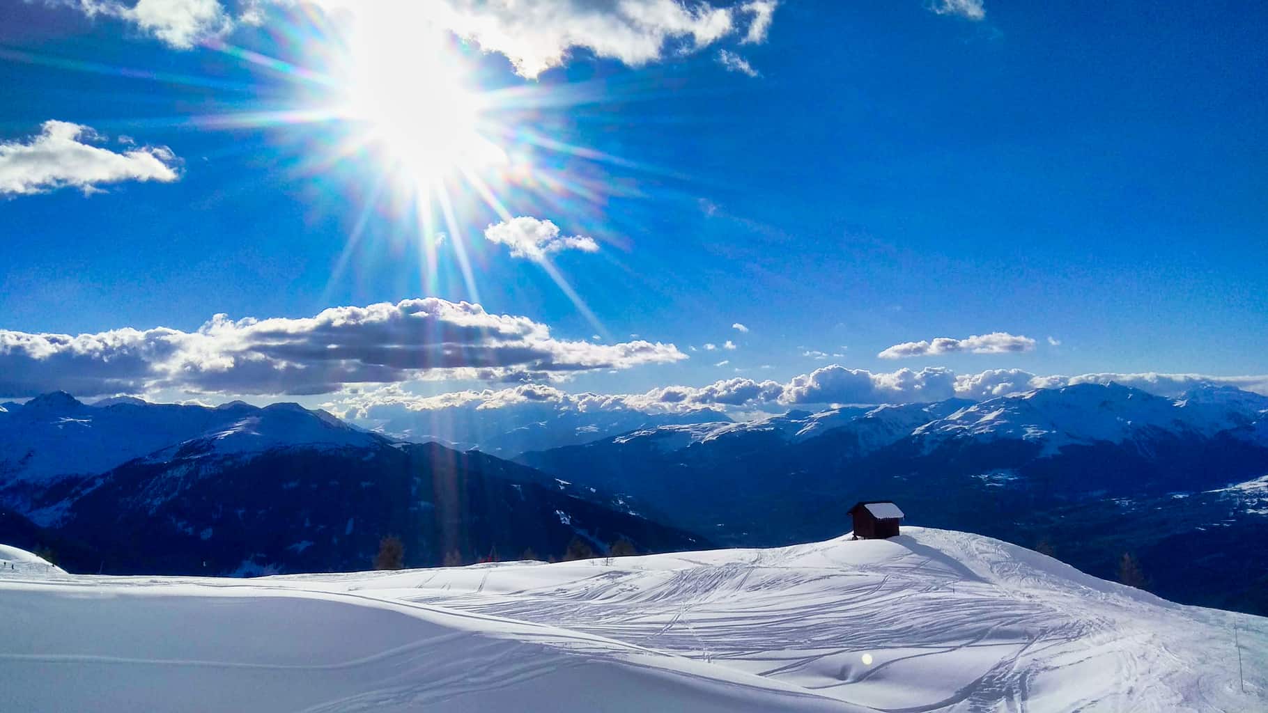 Hut on snowy ridge on mountain in Les Arcs