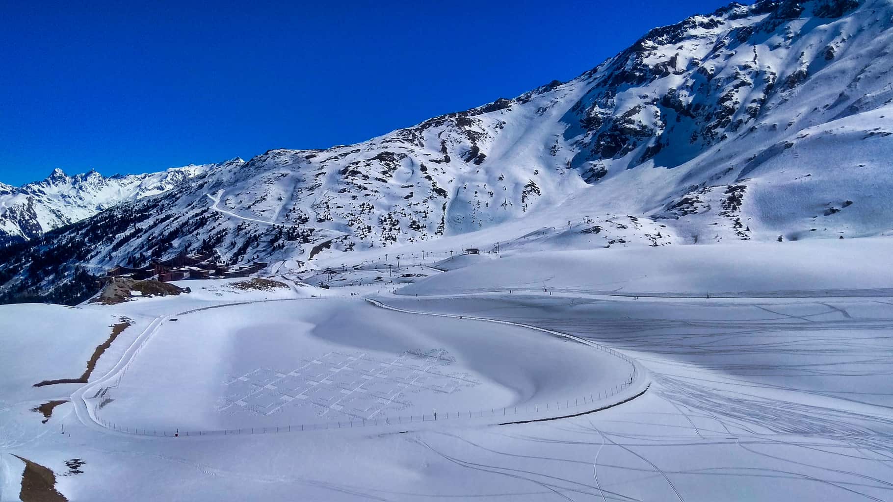 Snow art of a large snowflake by Simon Beck in Arc 2000 in Les Arcs