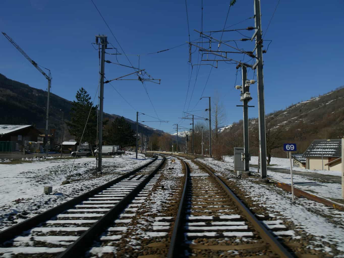 View of the French Alps from snowy train tracks