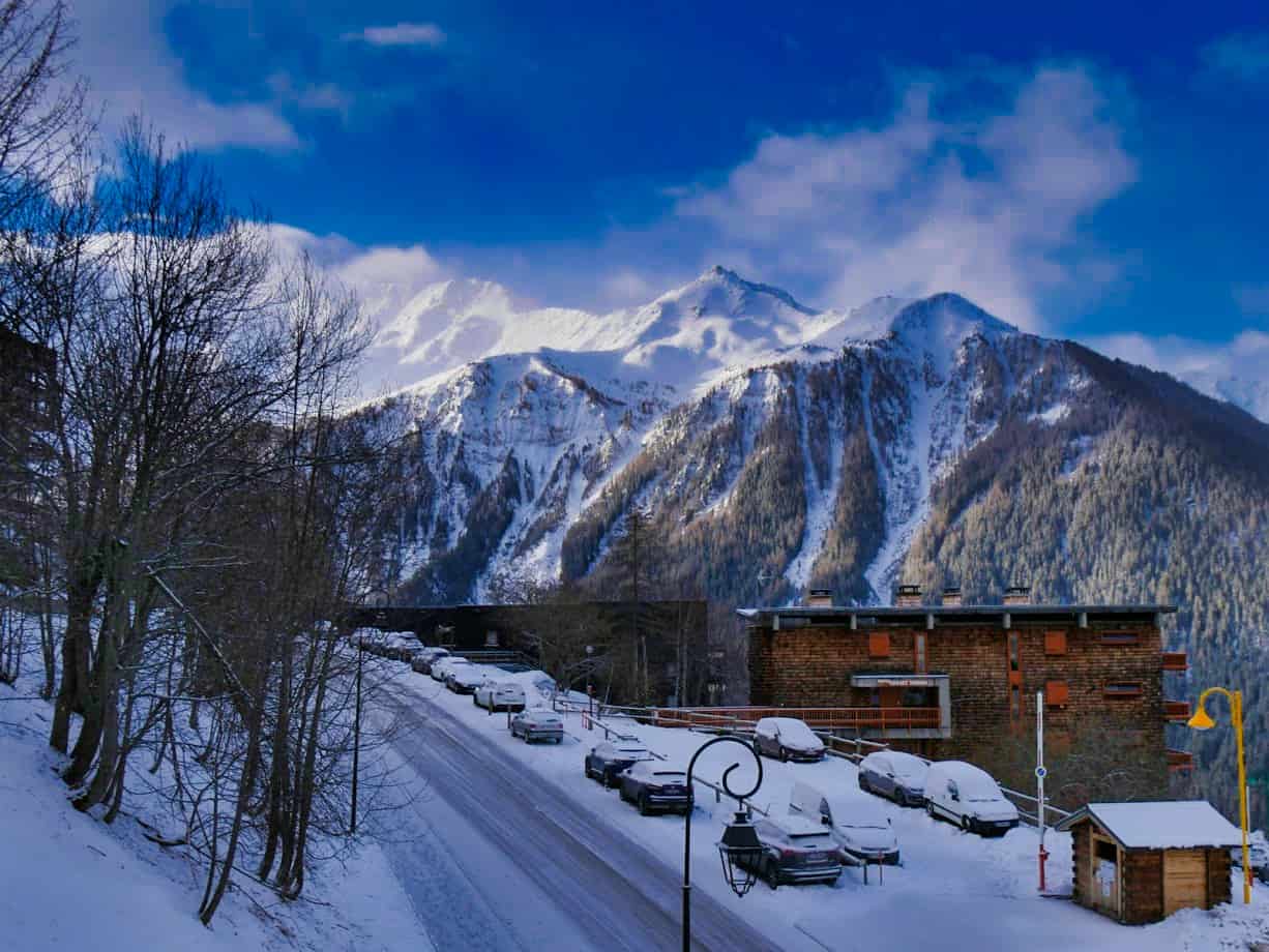 View from balcony in Peisey with deep blue sky and snowy mountain and snow-covered road