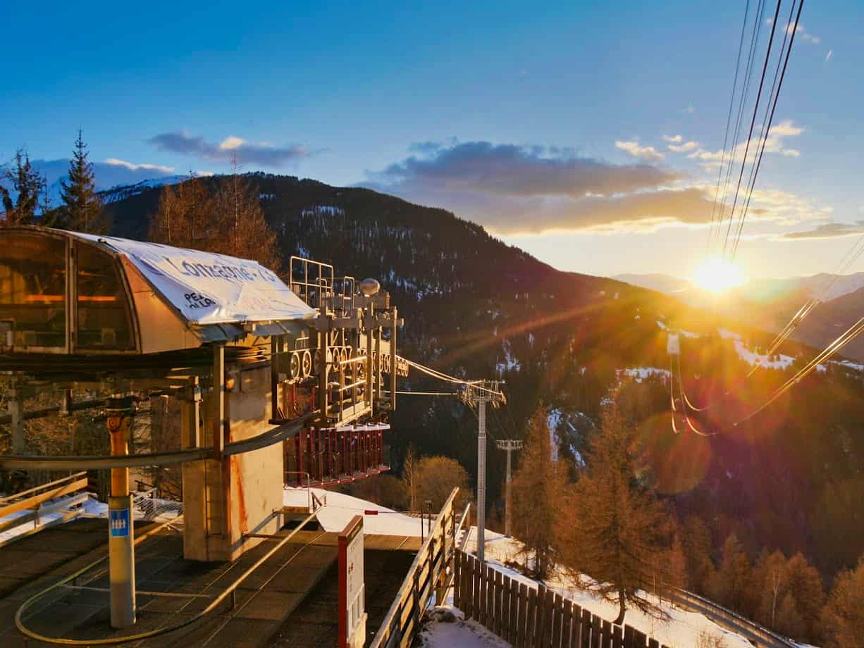 Entrance to Lonzagne bucket lift from Peisey down the mountain with sunset in the background