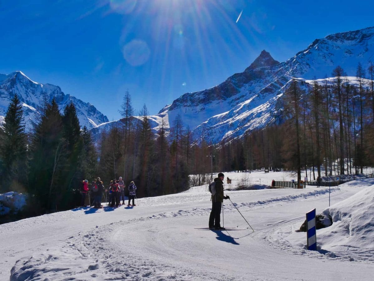Nordic Ski area in Paradiski with a cross-country skier and walkers surrounded by snowy mountains