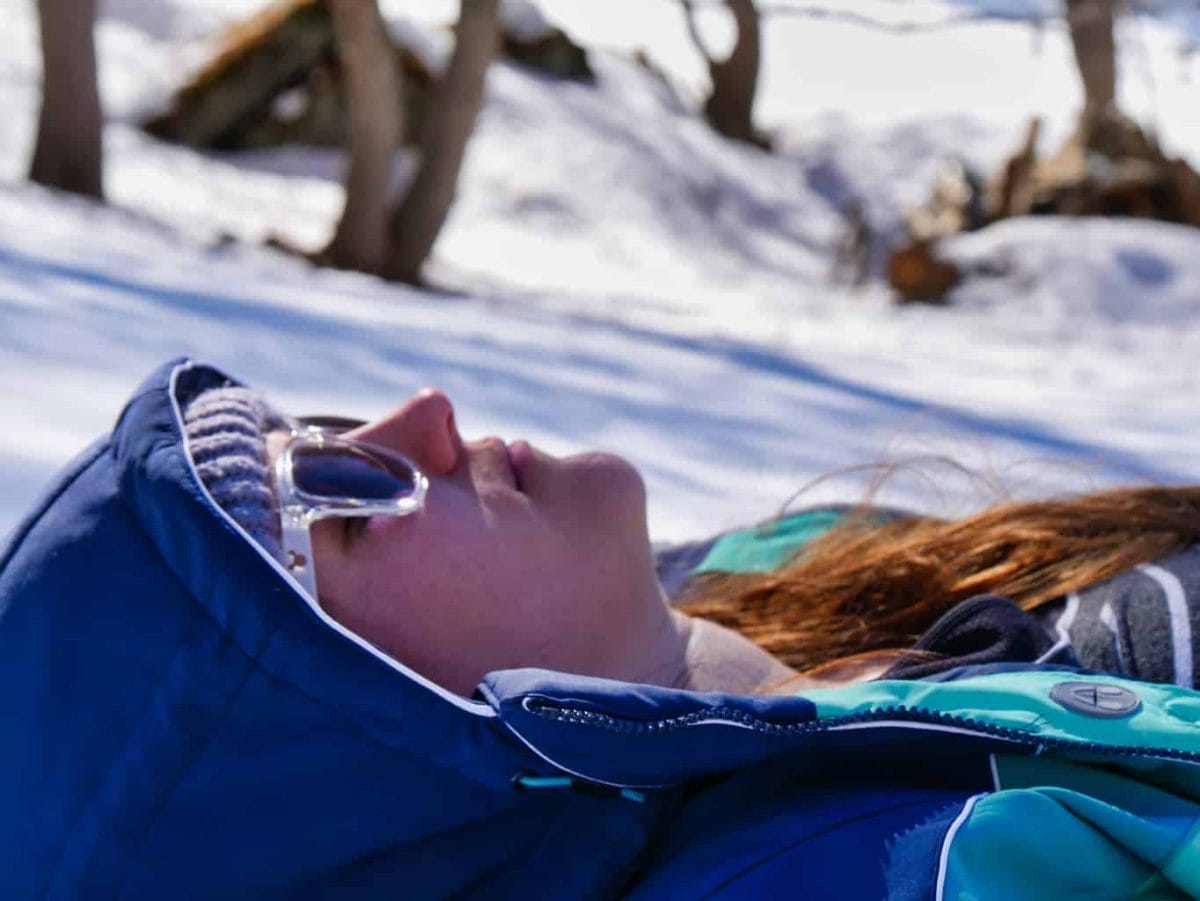Kalyn sunbathing in ski gear in the Nordic Ski Area in Paradiski
