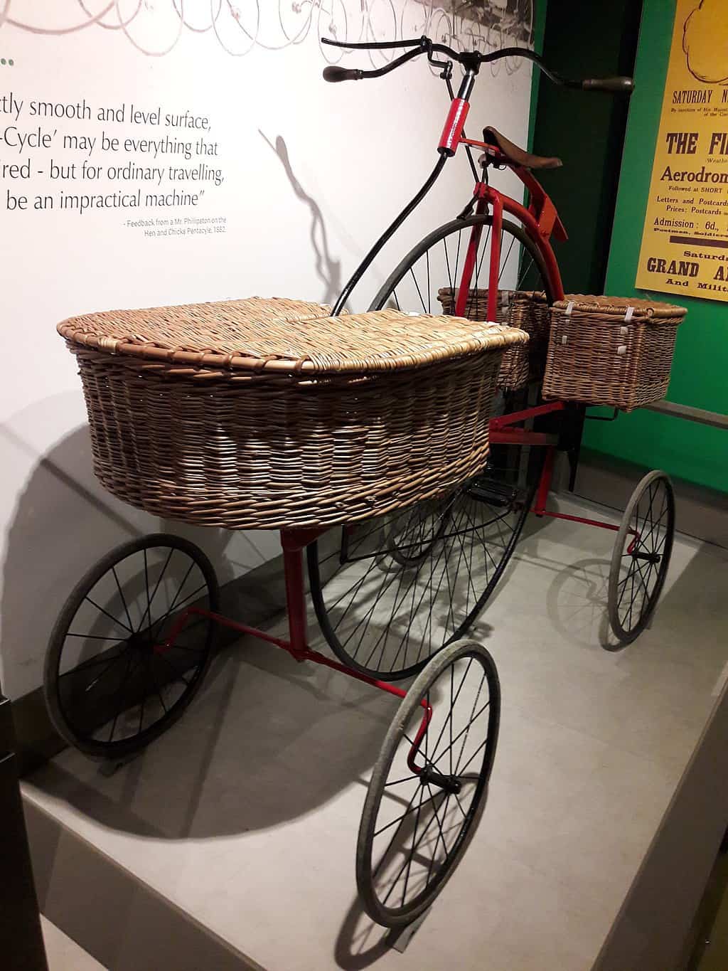Pentacycle in London Postal Museum with wicker baskets on front and back