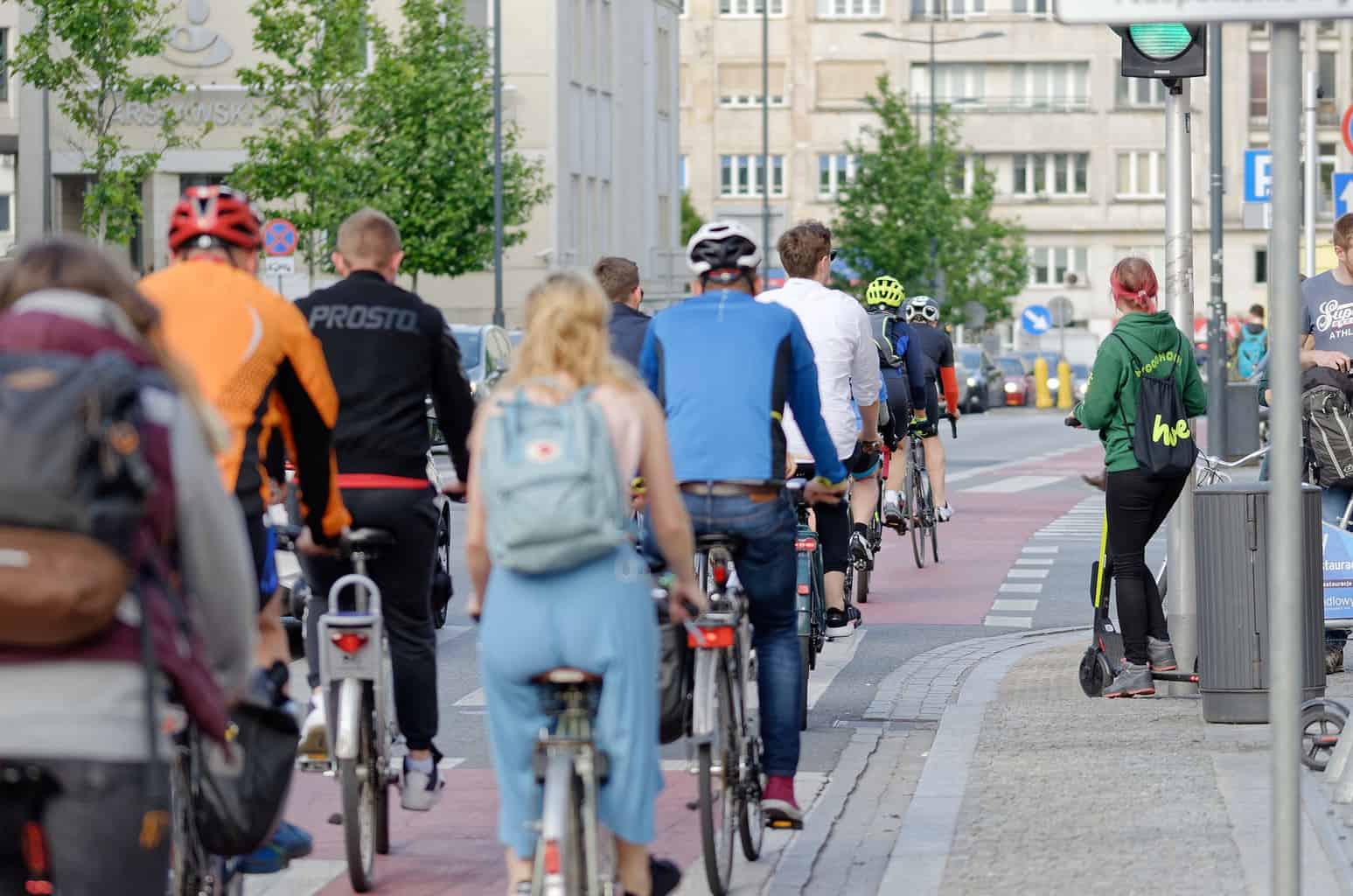 A group of cyclist riding along a road