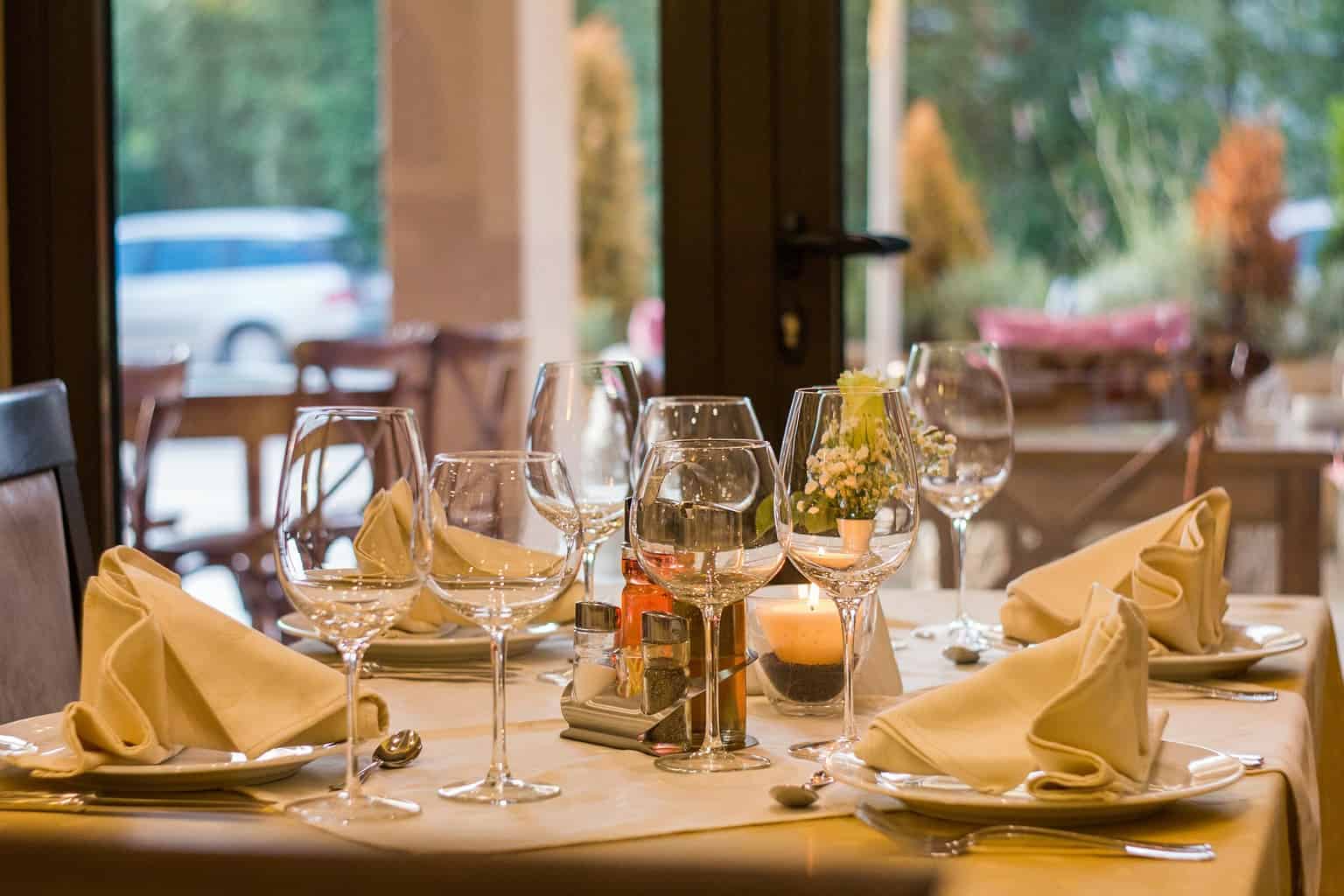 Tables laid at a restaurant with wine glasses prominent