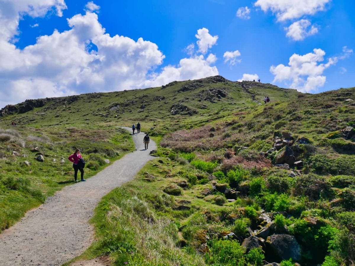 Path away from Kynance Cove leading up a hill with people walking on it