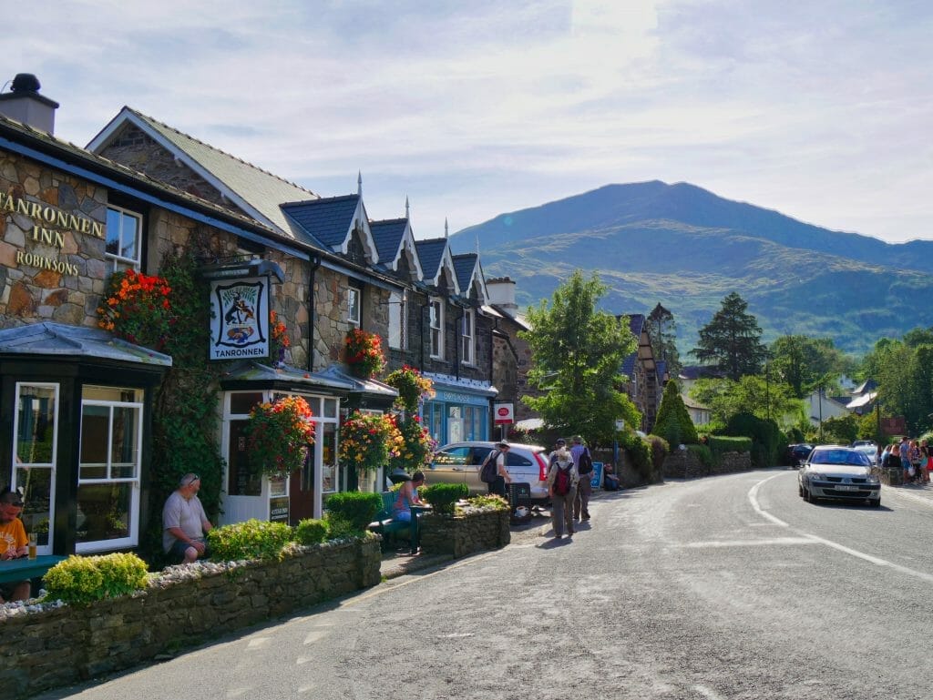 Things to do in Beddgelert Wales, stone shops on a street with hills behind