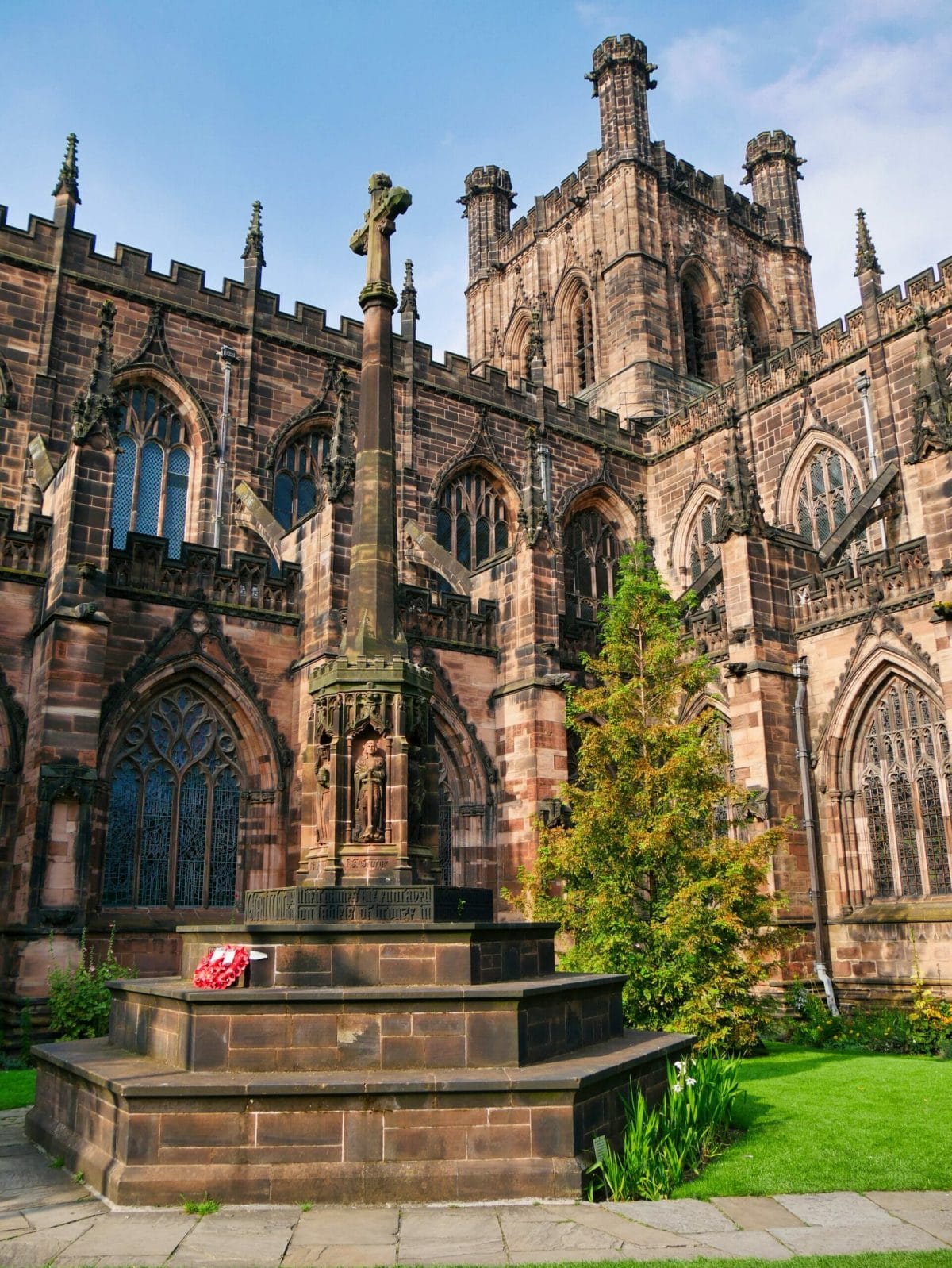 Chester Cathedral with a statue and tree in front