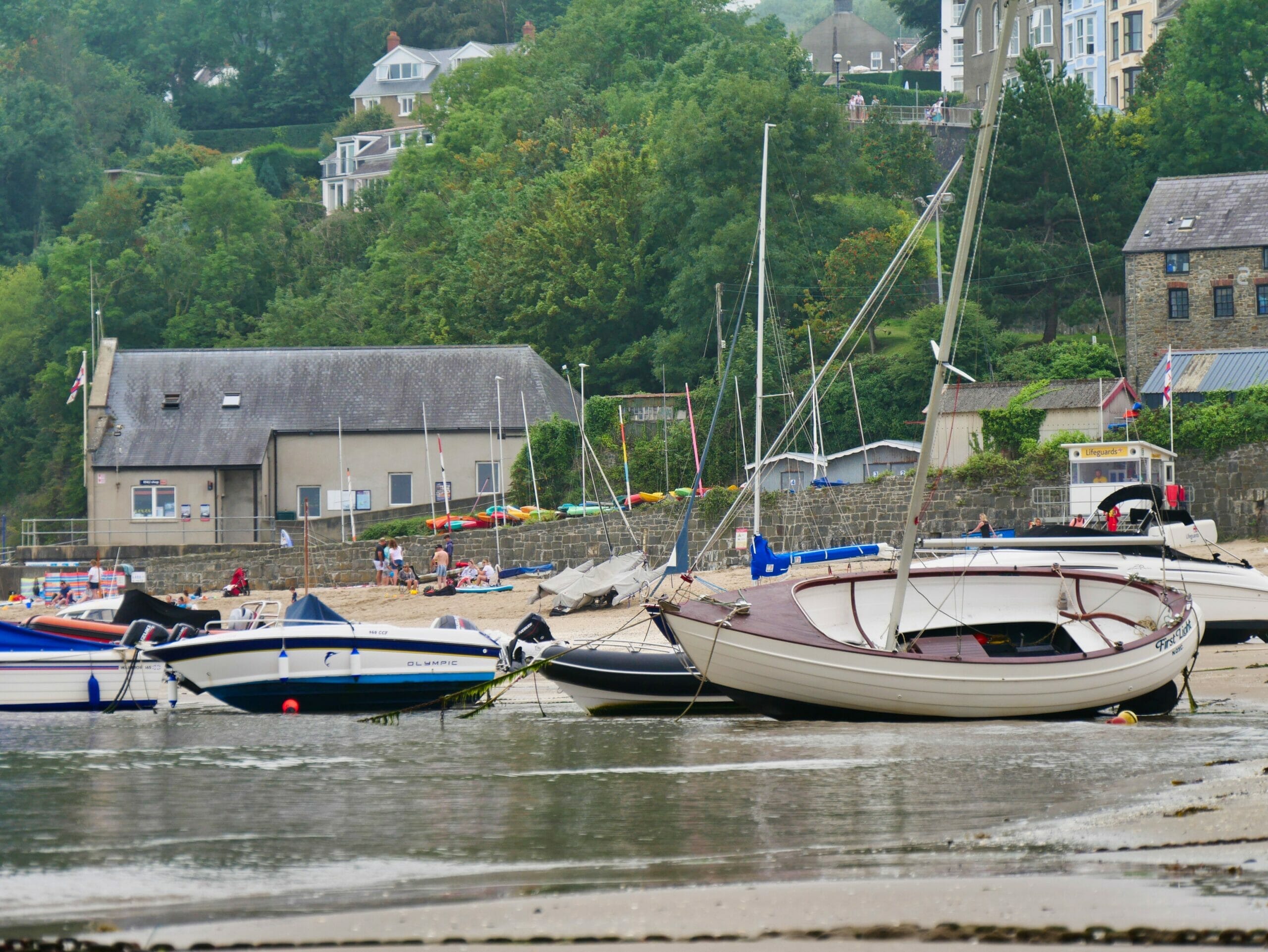 Some boats in the sandy water in New Quay in Wales