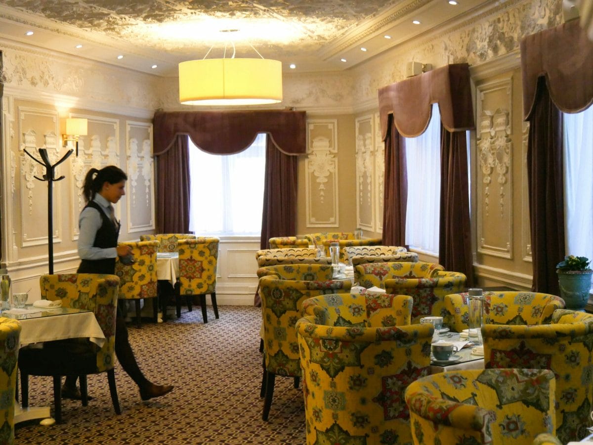 Inside of St. Ermin's Hotel with chairs and tables laid out for afternoon tea