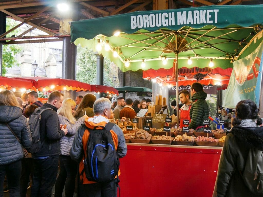 People milling around a food stand at Borough Market London