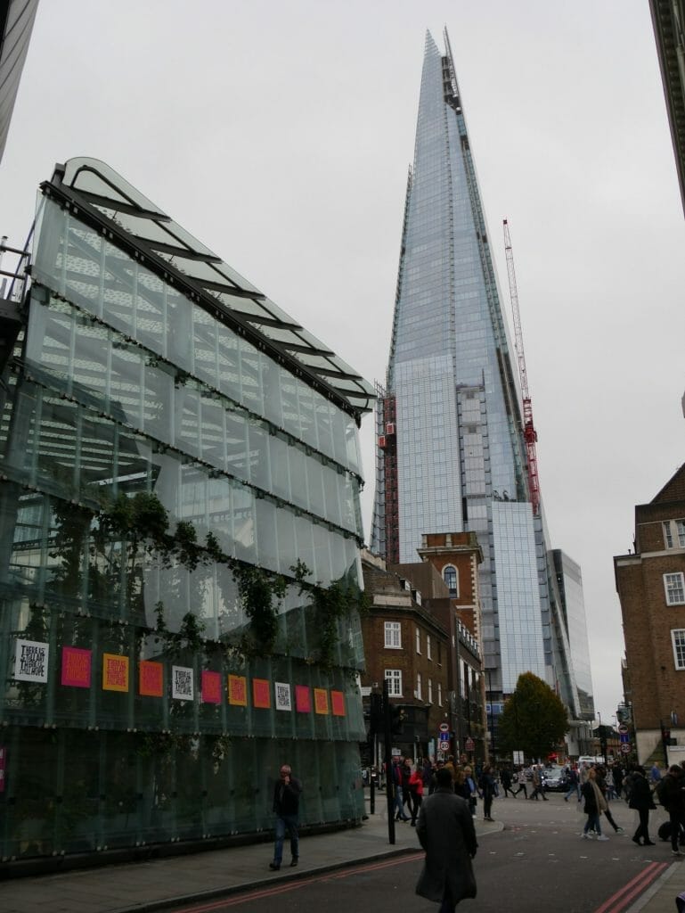 A glass building with The Shard in the background