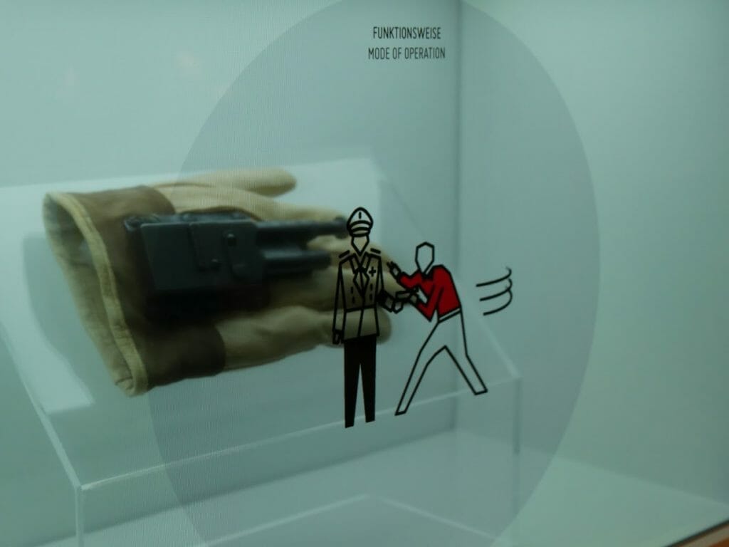 A gun hidden in a glove with an information screen over it