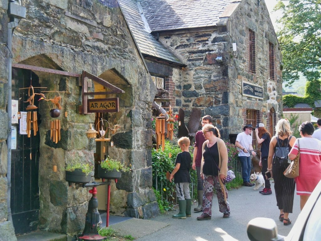 People outside stone shops in Beddgelert, Wales