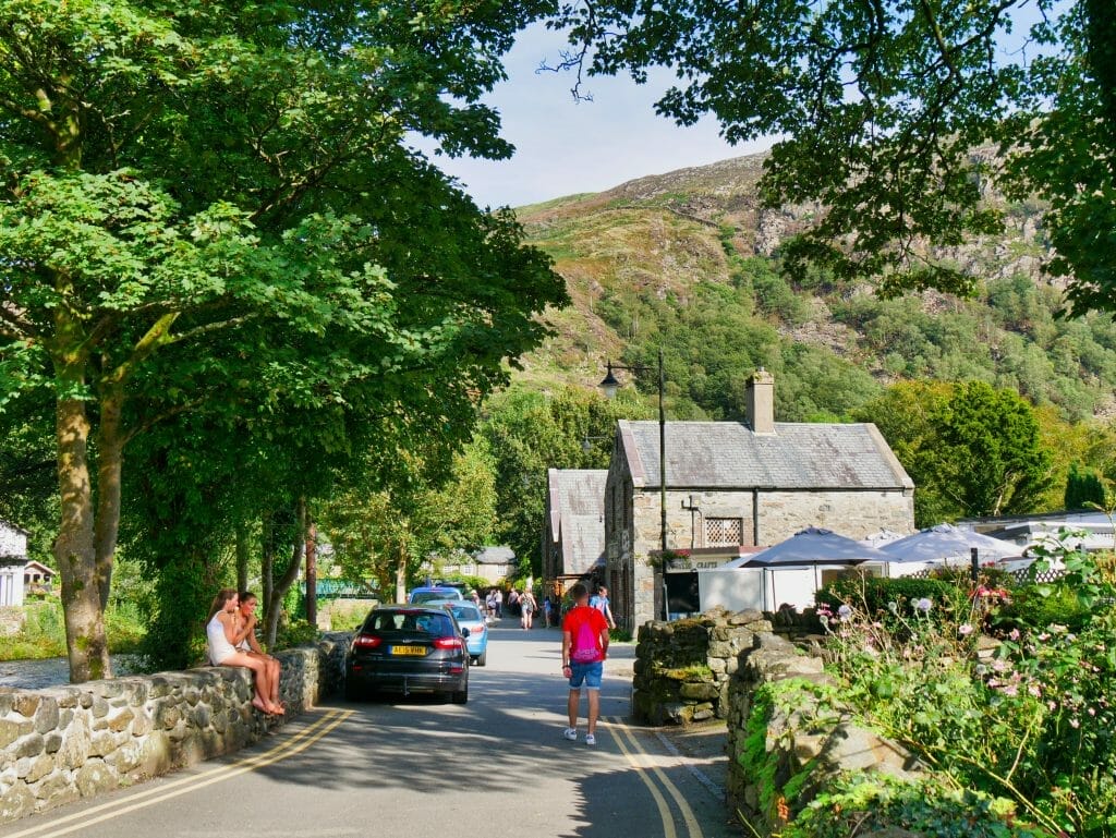 A road in Beddgelert, Wales, with people walking down it
