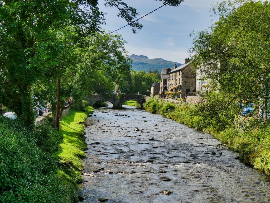 A river in Beddgelert, Wales, with buildings and trees to the side