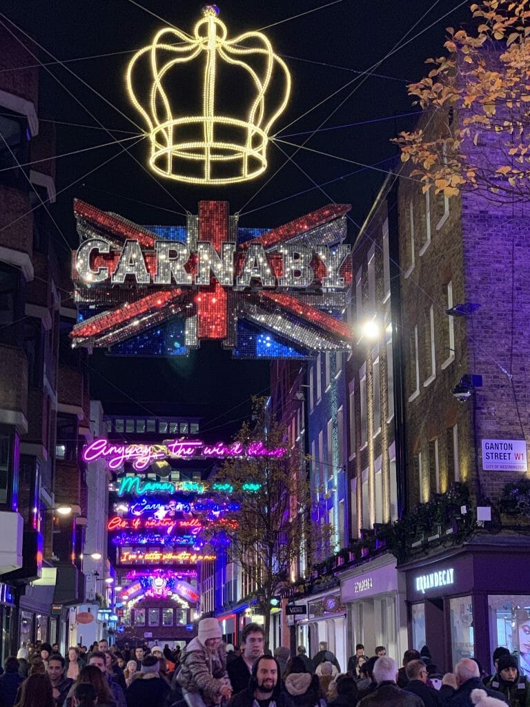 Christmas lights on Carnaby Street, London. One set of lights is the UK flag with a crown above it.