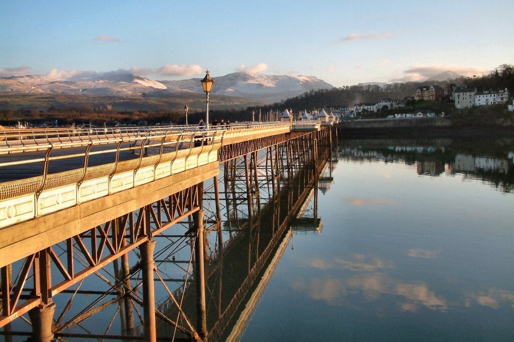 Sunset over Garth Pier in Bangor, North Wales, with mountains in the background