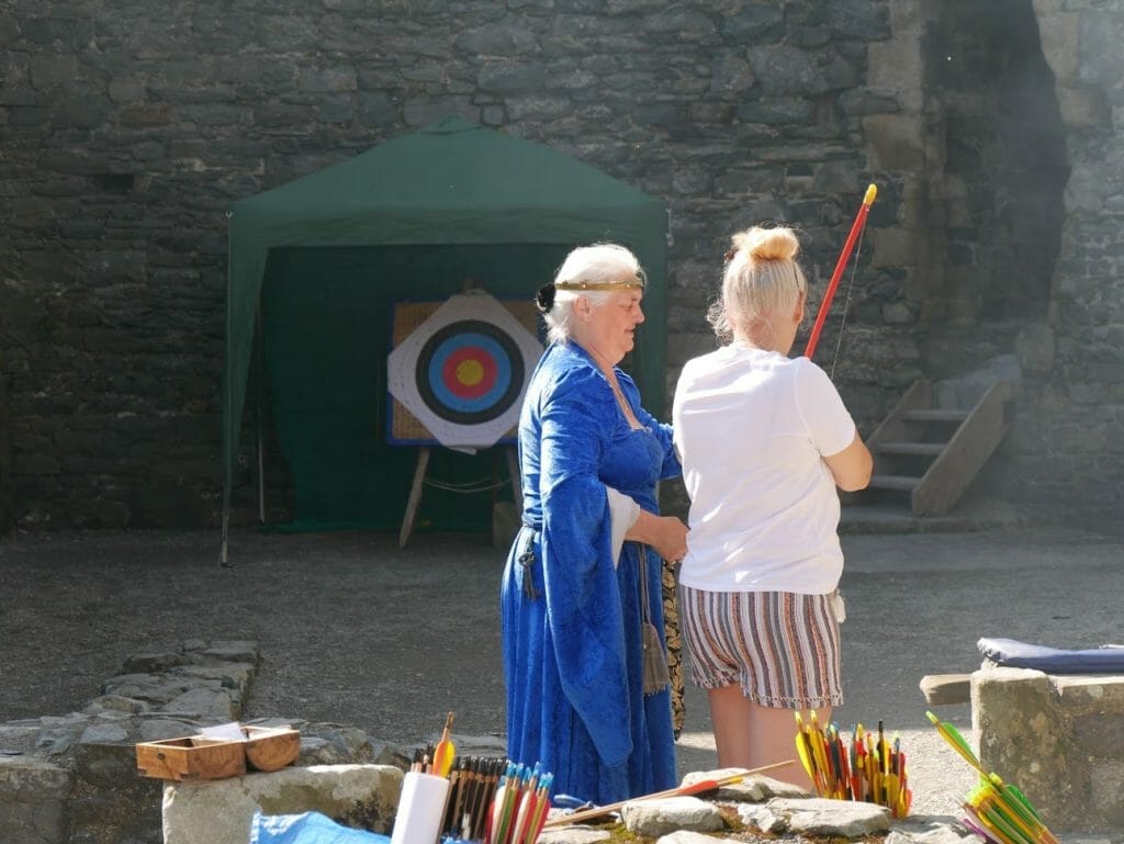 A lady learning to do archery in Harlech Castle in North Wales