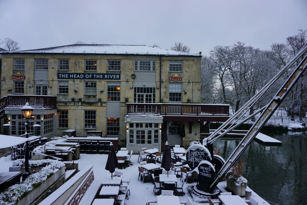 The Head of the River pub in Oxford, covered in snow, next to the river