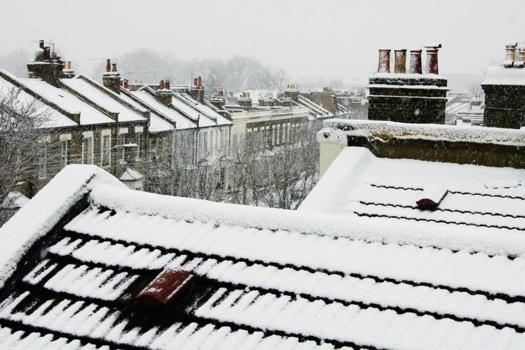 Snowy rooftops in London with thick cloud