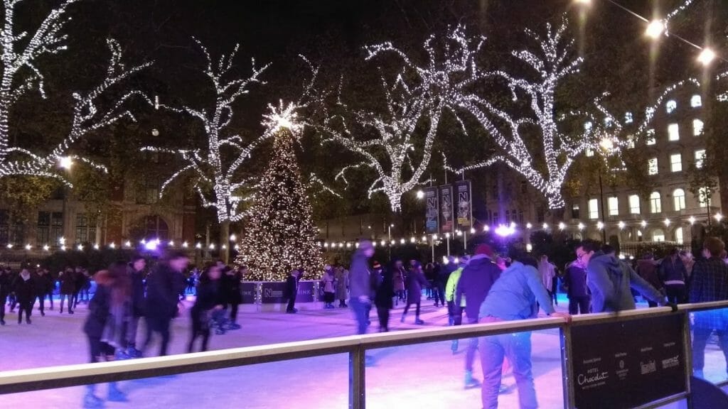 People ice skating outside the Natural History Museum in London in the winter