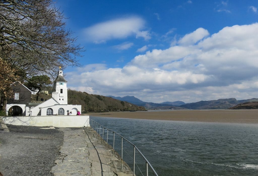 White building next to the water and sand at Portmeirion in North Wales