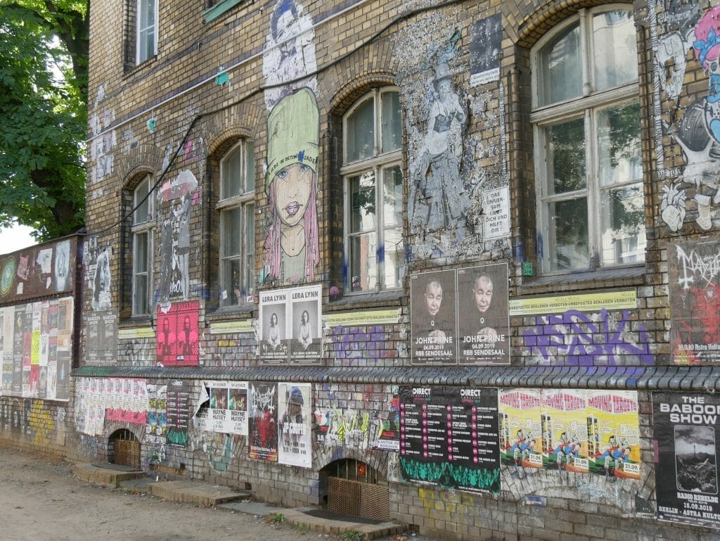 Graffiti and posters on a wall in Berlin seen on the Berlin Secret Food Tour