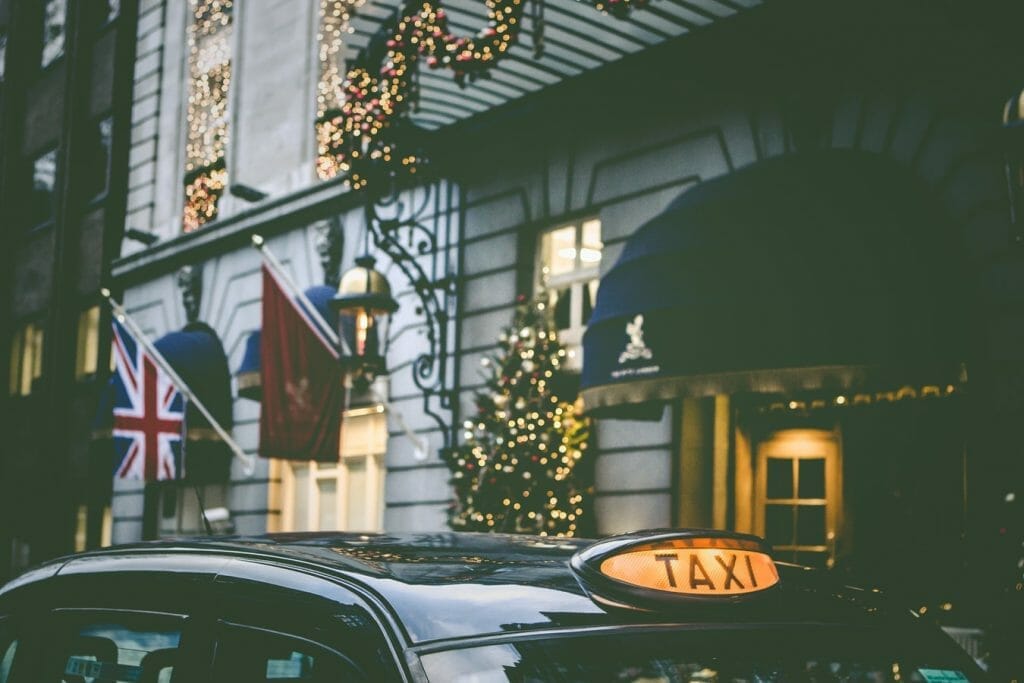 A taxi cab in front of a hotel in London