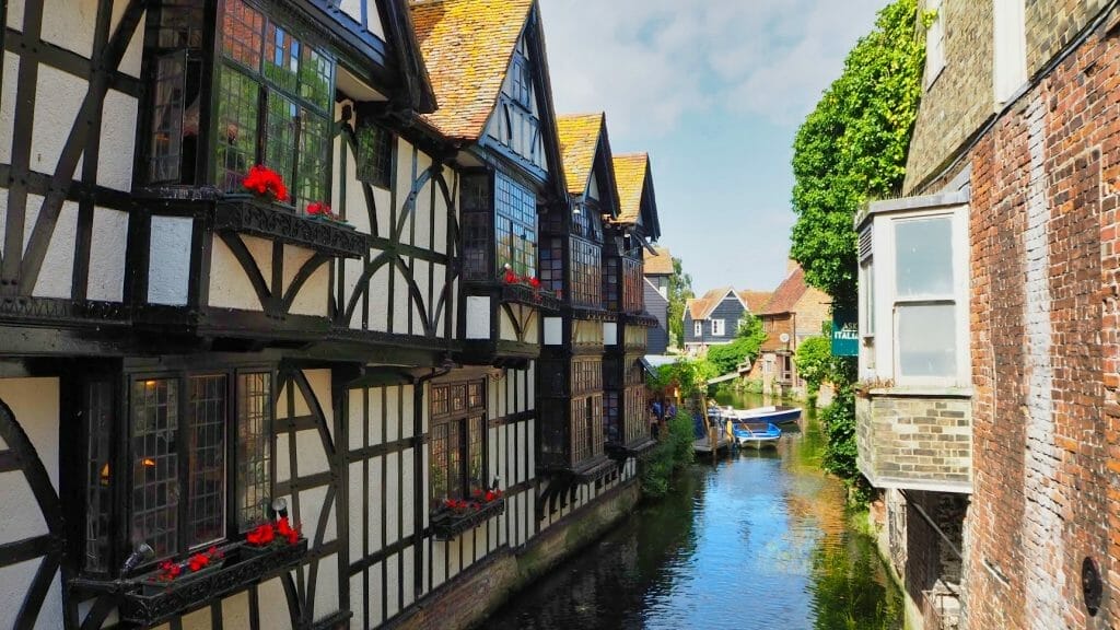 A river in between buildings in Canterbury