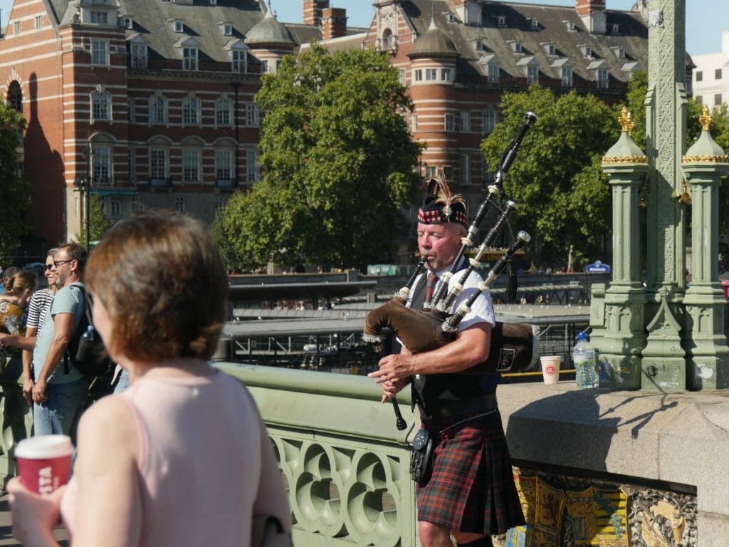 Man playing bagpipes in London