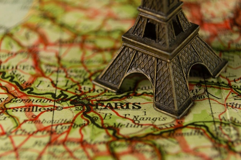 A map of Paris with a mini Eiffel Tower on it