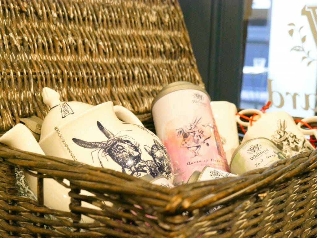 A wicker hamper with tea pots and mugs in it