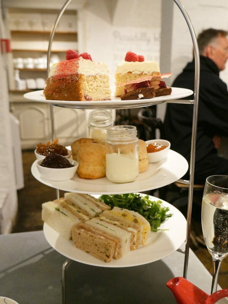 Afternoon tea sandwiches and cakes on a rack