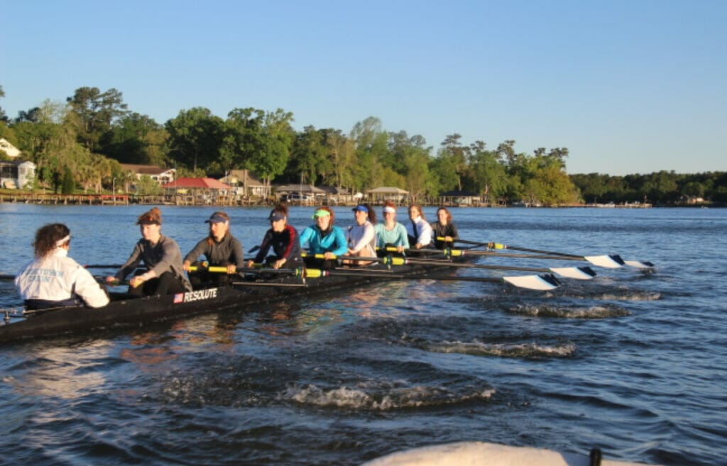 people rowing on a lake