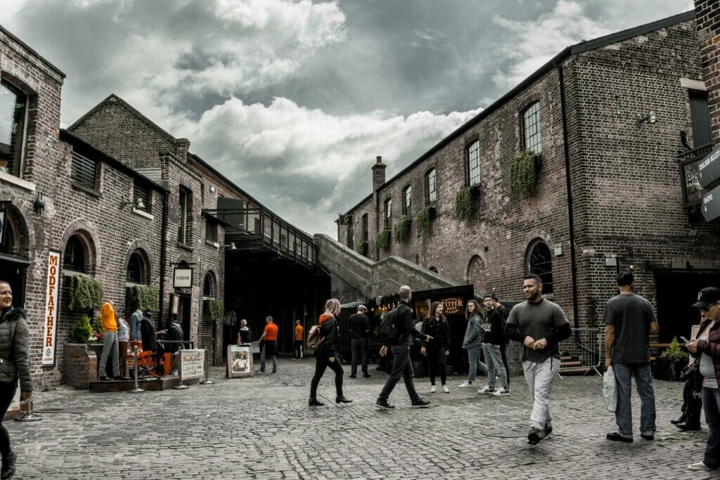 People walking through Camden Market with overcast sky