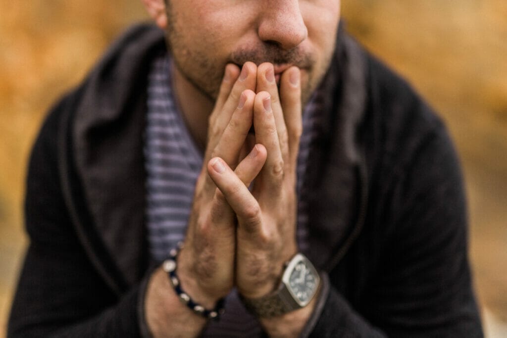 man with hands clasped