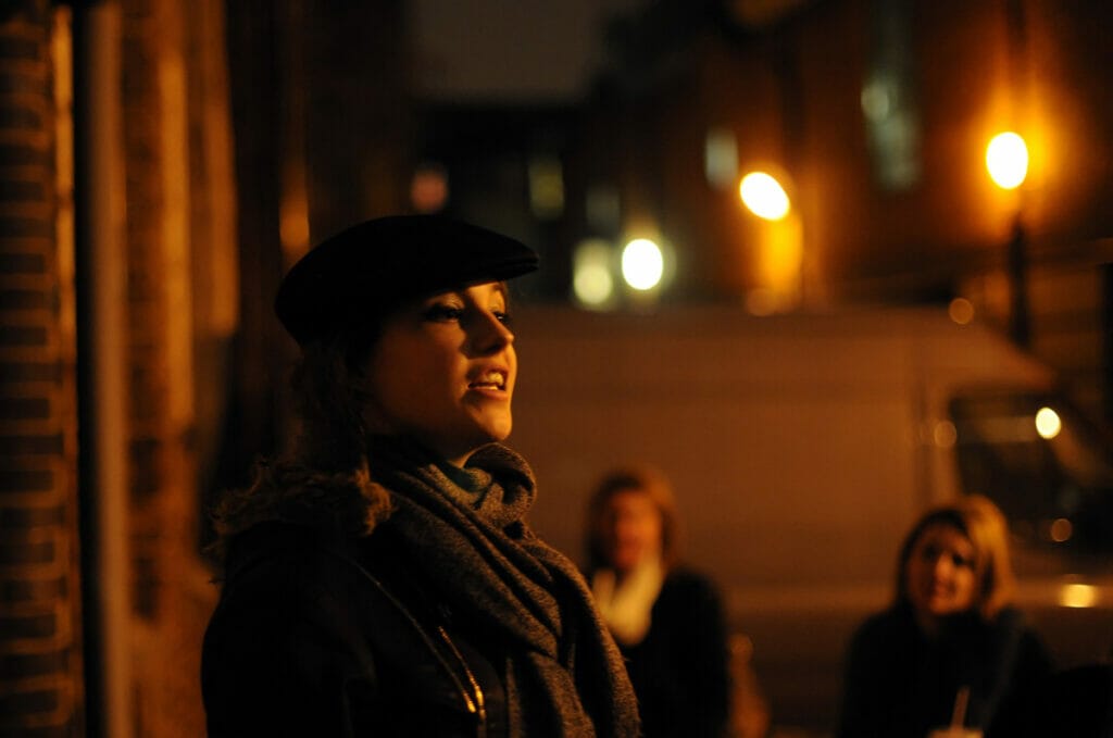 Woman leading a Jack the RIpper walk in the dark