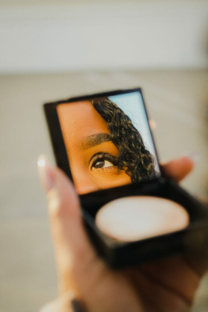 woman looking into mirror