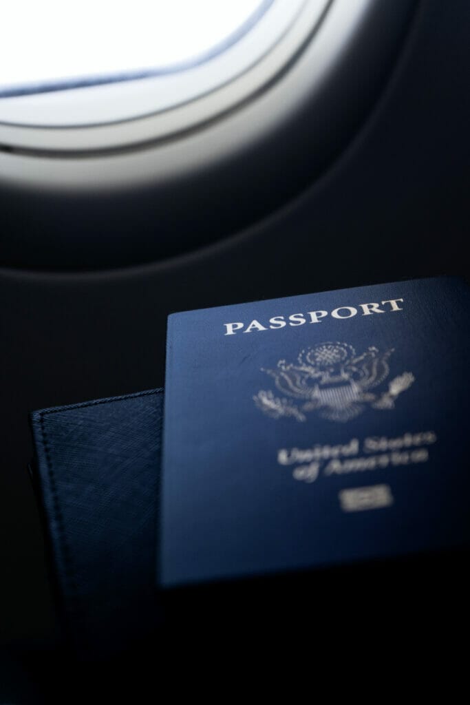 american passports next to plane window