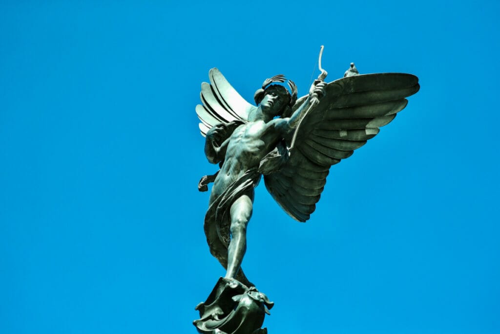 Eros Statue on Piccadilly Circus with blue sky in background